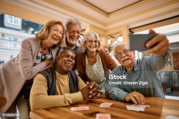 Cheerful Senior Having Fun While Taking Selfie At Retirement Community Stock Photo - Download Image Now