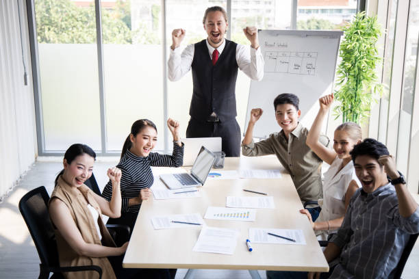 istock Team of business people doing happy gestures. 1413584083