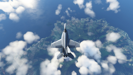 FA-18F Super Hornet aircraft flying over the sky and landscape green field