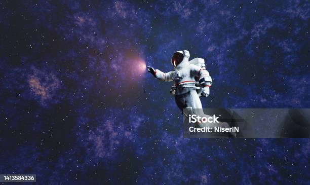 Astronaut Spacewalk In Space And Touching Orb Of Light Stock Photo - Download Image Now