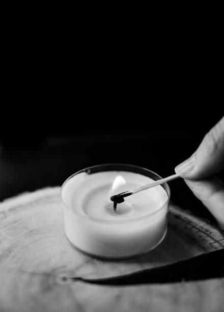 istock girl lights a candle 1413585777