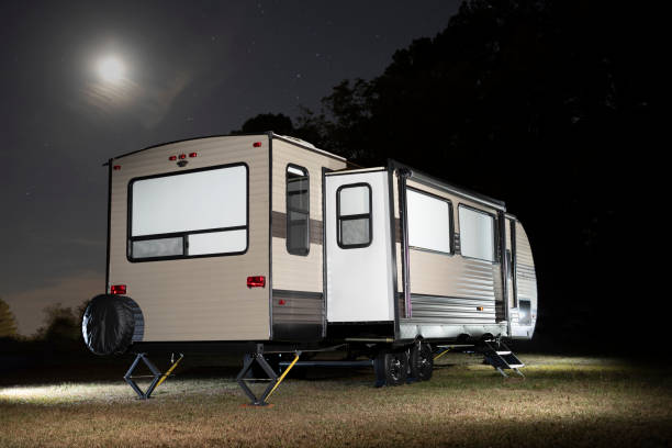 istock Camping trailer with slide out and moon above 1413588477