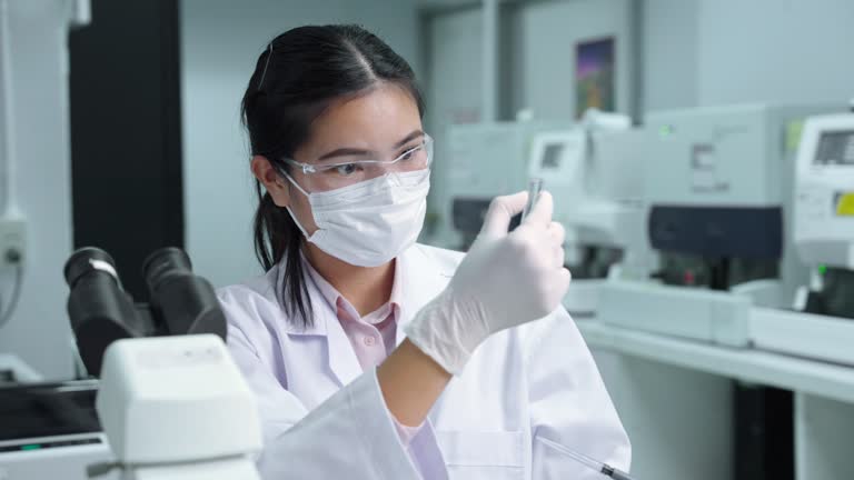 Lab technician in microscope room Research and development of antiviral drugs.