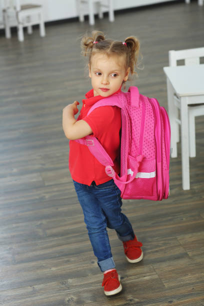 istock a pupil with a backpack on his back came to class. back to school 1413591700