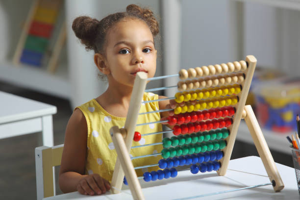istock A Black African-American girl is ready for a math and arithmetic lesson with an abacus. 1413591868