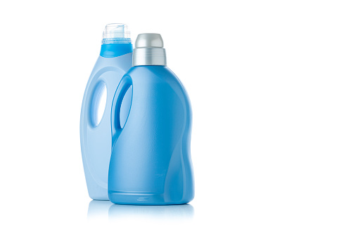 Front wiew of two blue plastic bottles of fabric softener isolated on white background. High resolution 42Mp studio digital capture taken with Sony A7rII and Sony FE 90mm f2.8 macro G OSS lens