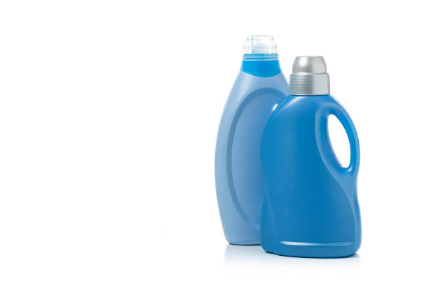 Green plastic jars with blue lids for storing chemical liquids and fuels and lubricants, close-up.