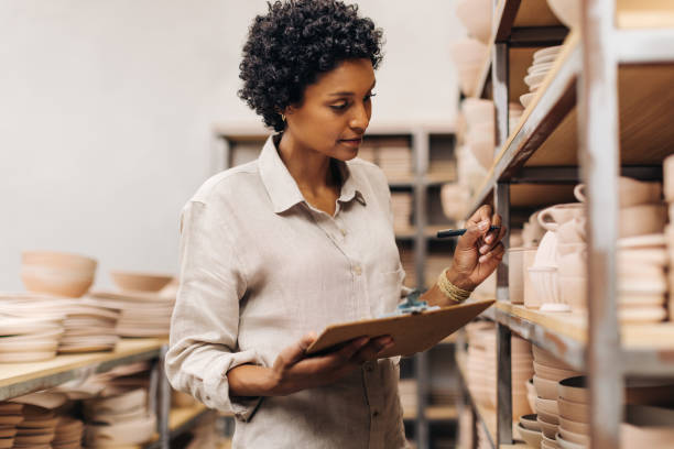 istock Ceramic shop owner taking stock in her store 1413596018