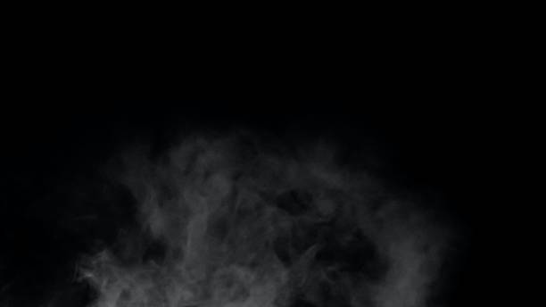 istock White smoke or fog isolated on black background. 1413596418