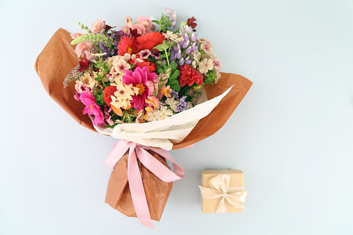 Bouquet of  soft pink flowers in pink wrapping paper.