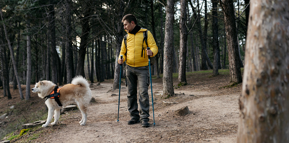 traveler man with his dog in the forest