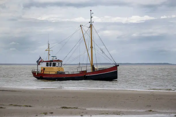 Old fishing cutter on the Wadden Sea in the north of the Netherlands