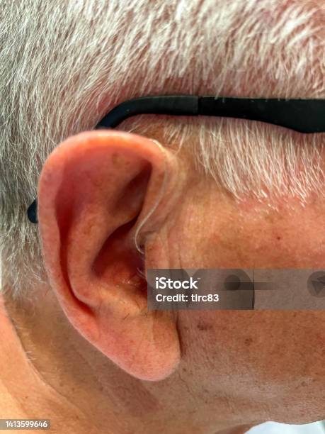 Senior Man Wearing Hearing Aid Closeup Stock Photo - Download Image Now - 70-79 Years, Active Seniors, Adult