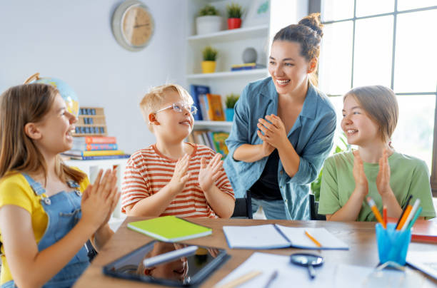 istock Happy kids and teacher at school 1413600806