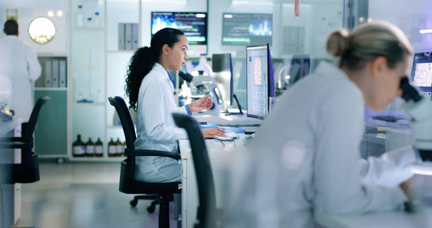 laboratory scientist with microscope and computer looking, analyzing or testing dna chemical reaction in medical research. healthcare biologist in science experiment for monkeypox pandemic virus cure - dna research forensic science healthcare and medicine imagens e fotografias de stock