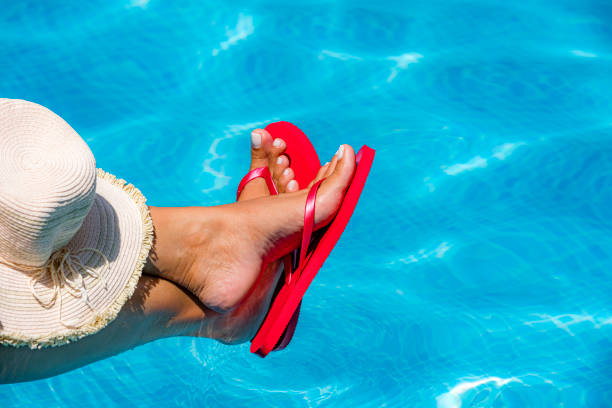 istock Woman with red flip flops by the pool 1413602530
