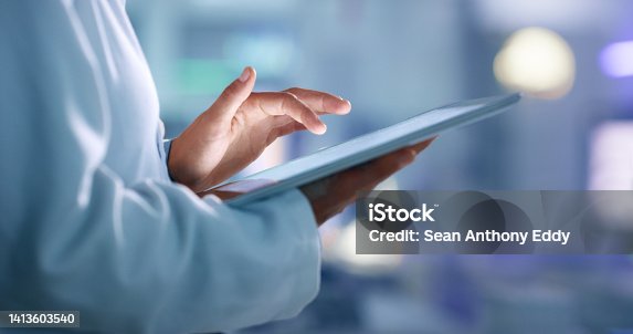 istock Doctor, researcher or scientist browsing the internet on a tablet for information while working at a lab, science facility or hospital. Expert, medical professional or surgeon searching the internet 1413603540
