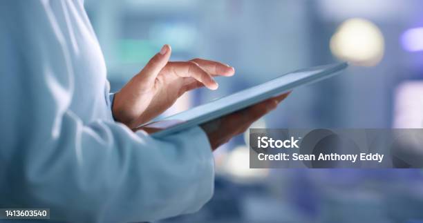 Doctor Researcher Or Scientist Browsing The Internet On A Tablet For Information While Working At A Lab Science Facility Or Hospital Expert Medical Professional Or Surgeon Searching The Internet Stock Photo - Download Image Now