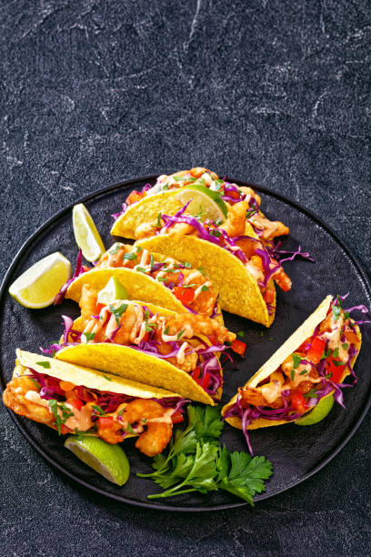 istock Bang Bang Shrimp Tacos on black plate with sauce 1413604384
