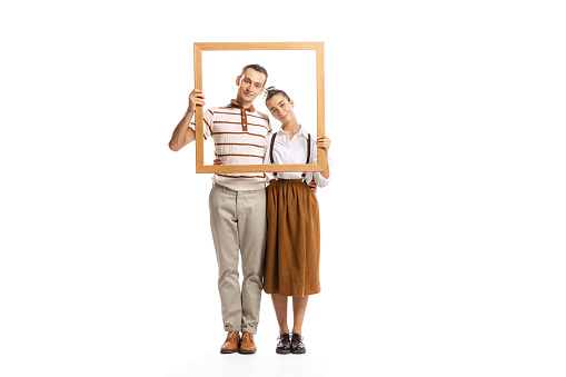 Portrait of man and woman posing together in a picture frame isolated white on background. Retro style. Family look. Concept of fashion, relationship, cooperation, creativity, business, expression, ad