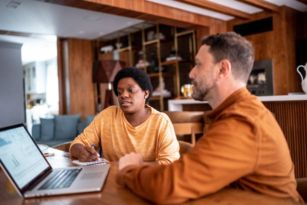 istock Mature couple using laptop doing home finances 1413607260