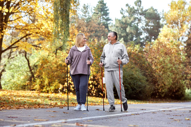 Senior caucasian couple hiking together at the park stock photo