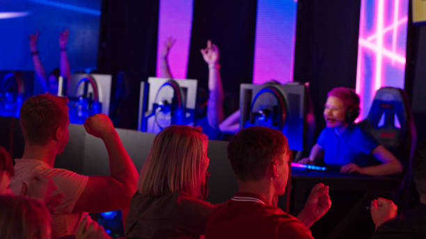 istock Audience watching esport video game championship on a huge display screen. Cheering and clapping for their favorite players 1413607792