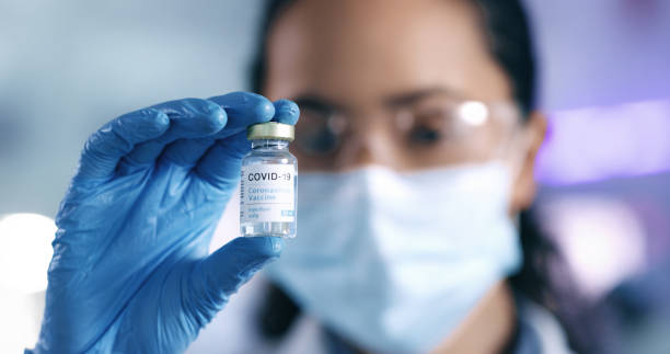 istock Holding a vaccine medication cure for covid while working in a lab. Vaccination and research help provide us with protection and cure from disease. Closeup of a scientist holding a bottle of medicine 1413607805