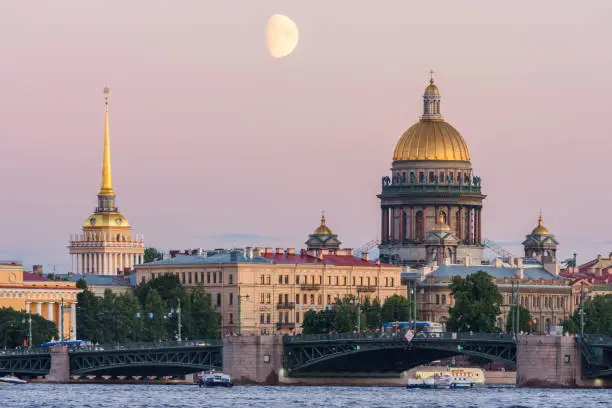 Photo of St. Petersburg cityscape with Saint Isaac's cathedral, Admiralty building and Palace bridge at sunset, Russia