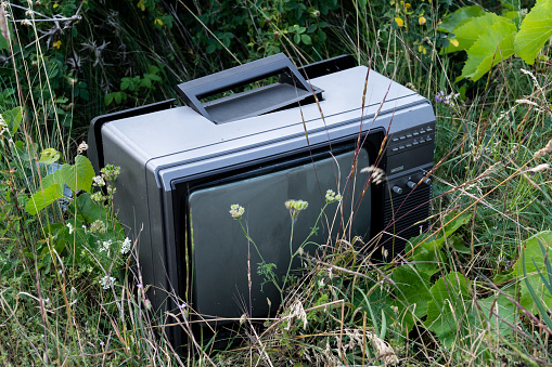 Old Damaged Tube Television Illegally Dumped On A Meadow Endangering Nature With Hazardous Substances