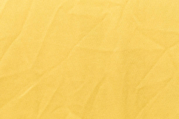 el fondo de textura de tela de color amarillo de la ropa, vista superior de la superficie textil de tela - laundry basket fotografías e imágenes de stock