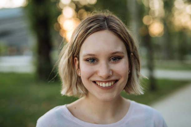 istock Generation Z woman with pierced nose smiling, looking at camera 1413610616