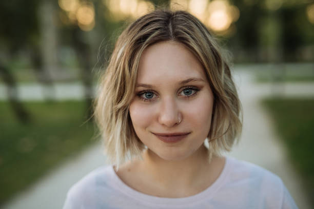 istock Generation Z woman with pierced nose smiling, looking at camera 1413610666
