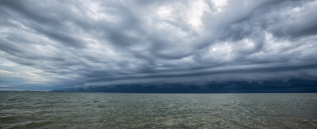 Cloudy storm in the sea before rainy. Tornado storms cloud above the sea. Monsoon season. Huge storm clouds with rain over sea , Strong winds, heavy rain storm. Hurricane Florence.