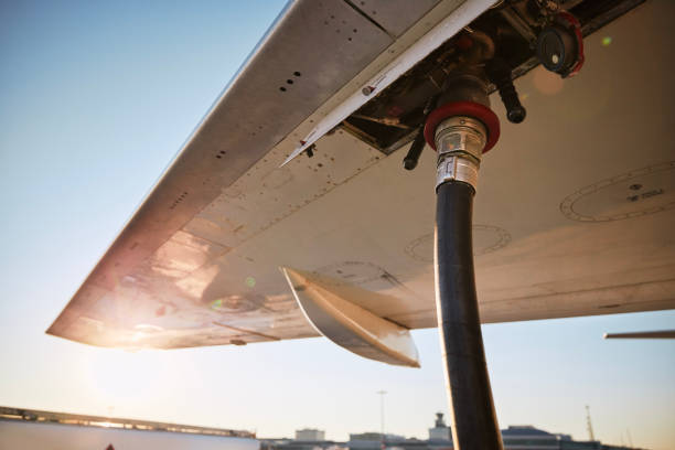 Refueling of airplane at airport Refueling of airplane at airport. Ground service before flight. fossil fuel stock pictures, royalty-free photos & images