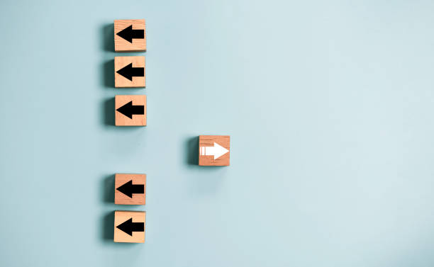 istock White arrow move out from different direction from many black arrow for business and technology disruption concept. 1413614403