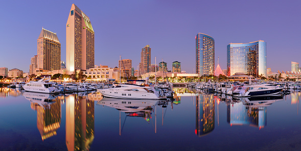 night time view of the San Diego skyline and recreational boats in San Diego bay.