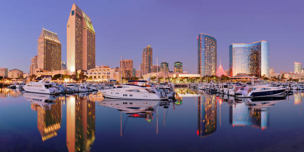 San Diego - Skyscrapers + Marina night time view of the San Diego skyline and recreational boats in San Diego bay. marina california stock pictures, royalty-free photos & images