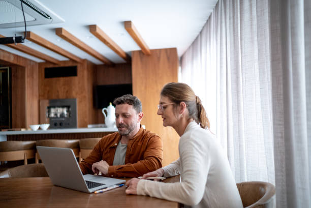 istock Mature couple talking and using the laptop at home 1413616227