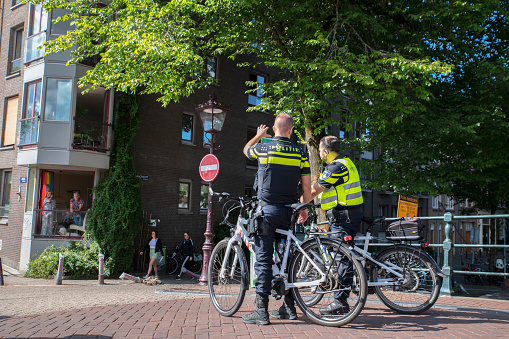 Two Police Men On Bicycles At Amsterdam The Netherlands 6-8-2022