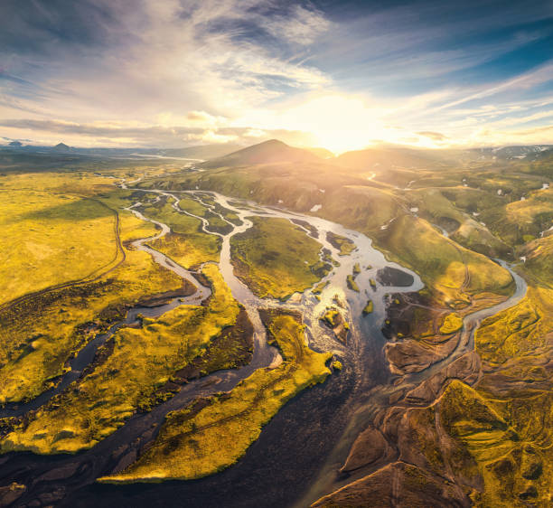 istock Sunset over volcanic mountain and abstract glacier rivers flowing through moss field in Icelandic highlands 1413621338