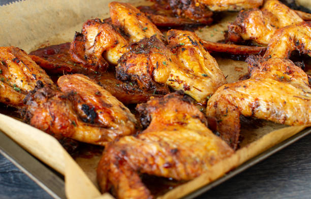 istock Roasted chicken wings on baking tray  background, ready to eat 1413622686