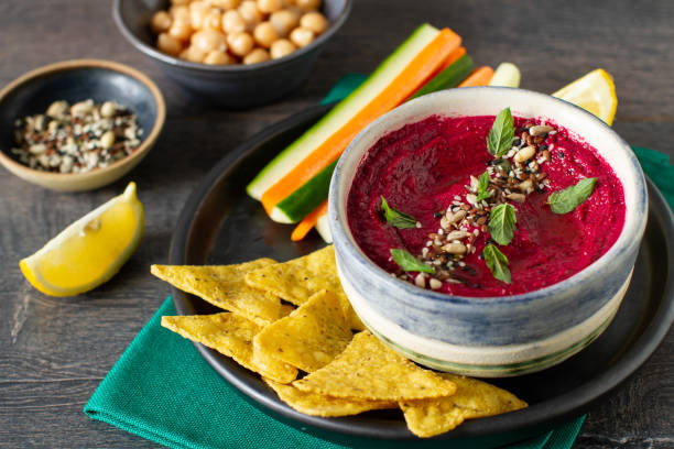 istock Roasted beet hummus with vegetables in a ceramic bowl on a gray background. 1413623367