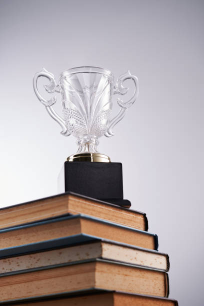 istock crystal trophy on top stack of books 1413624178
