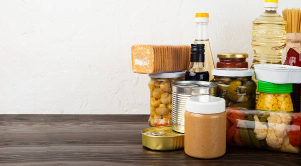 istock Emergency survival food set on dark wooden kitchen table 1413625444
