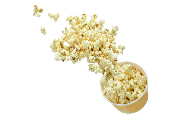 salty popcorn floating from paper bowl in white background stock photo
