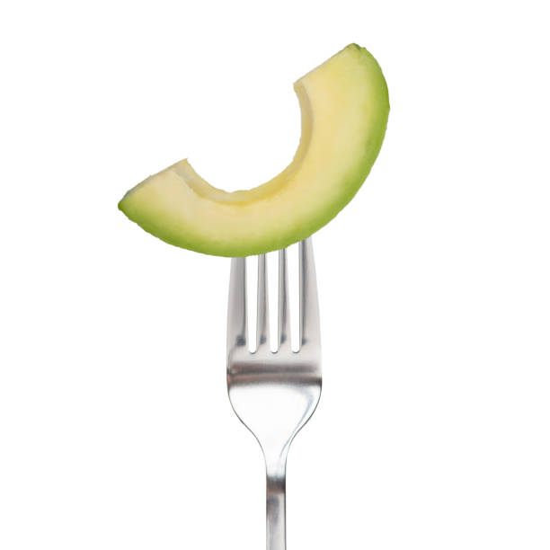 istock a piece of avocado on a fork on a white isolated background 1413626005
