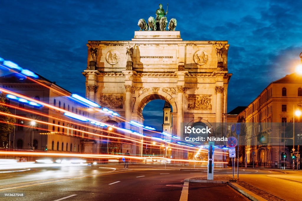 Victory Gate in Munich with blurred light lines of traffic at blue hour Munich Stock Photo
