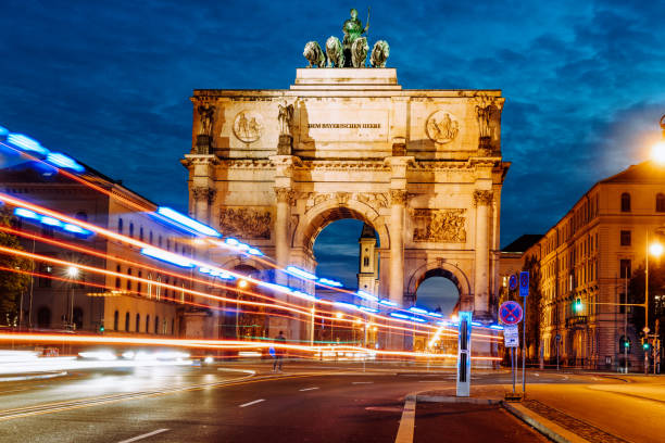 Victory Gate in Munich with blurred light lines of traffic at blue hour stock photo