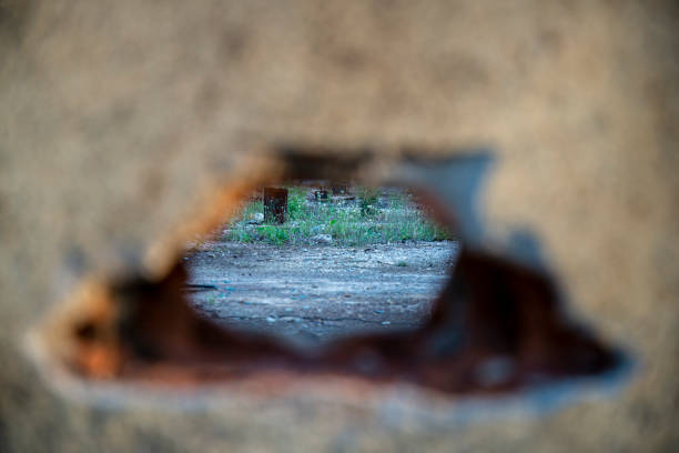 istock Close-up view of an embossed textured wall. The image is suitable for abstract background. An old broken brick wall. There is a hole middle of the wall. Focus is not on the wall 1413628582